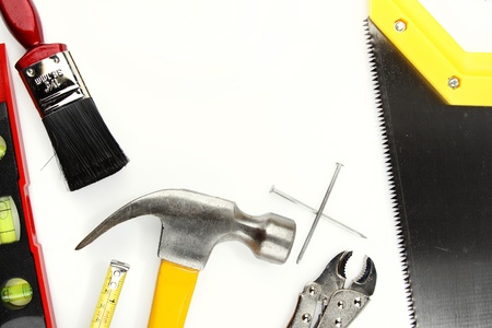 Assorted work tools on plain background