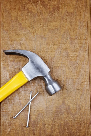 Hammer and nails on wooden panelの写真素材