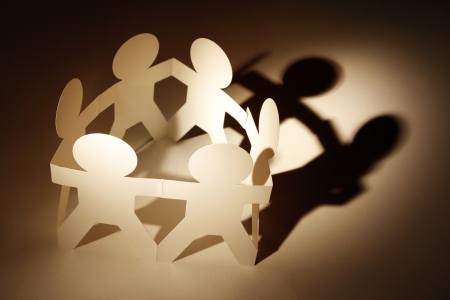 Team of paper doll people in a circleの写真素材