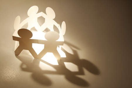 Team of paper doll people in a circle