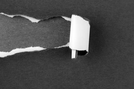 Hole ripped in black and white paper の写真素材