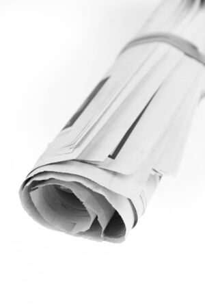 Newspaper, rolled up, on plain backgroundの写真素材