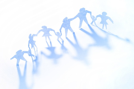 Group of paper doll people holding hands