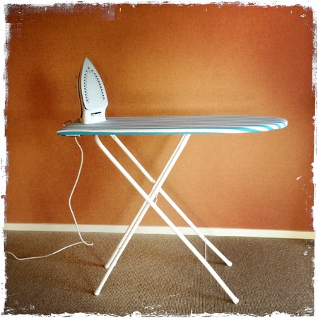 Iron on top of ironing boardの写真素材