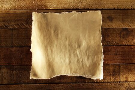 Piece of torn paper on boardsの写真素材