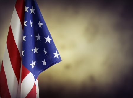 American flag in front of plain background. Advertising space