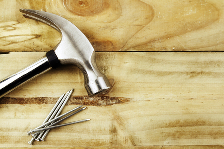 Hammer and nails on wood の写真素材