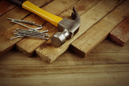 Hammer and nails on woodの写真素材