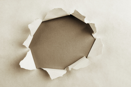 Hole ripped in paper, space for copyの写真素材