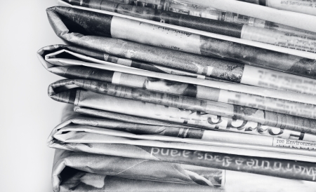 Closeup of newspapers on plain backgroundの写真素材