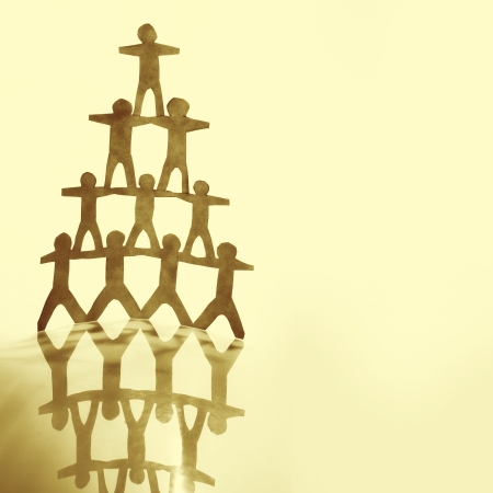 Human team pyramid on brown の写真素材