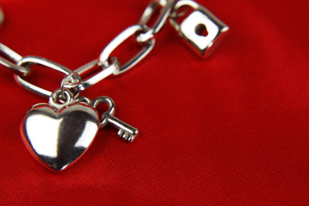 Closeup of heart and key on charm braceletの写真素材