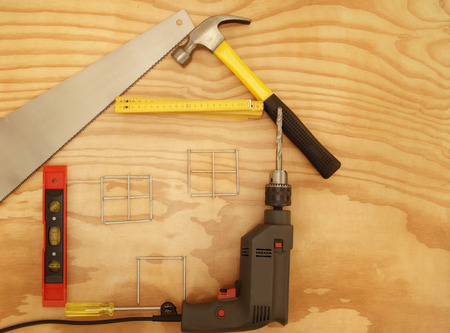 Work tools in shape of house on woodの写真素材