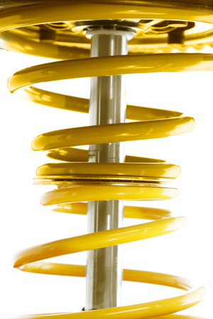 Closeup of coil spring on white の写真素材