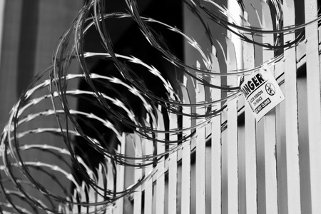 Razor wire on top of fenceの写真素材