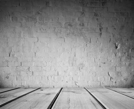 Wooden floorboards and brick wall の写真素材