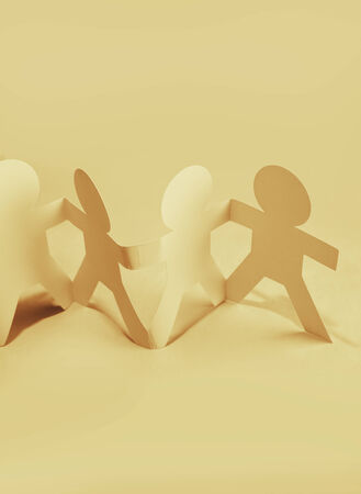 Paper doll people holding handsの写真素材