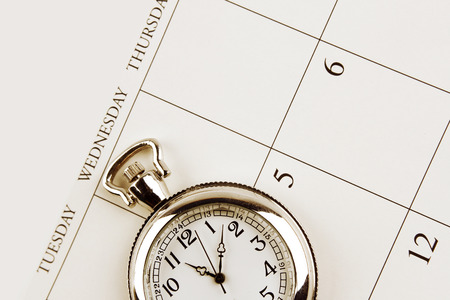 Closeup of watch on calendarの写真素材
