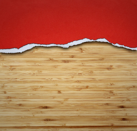 Ripped paper on wood, space for copyの写真素材