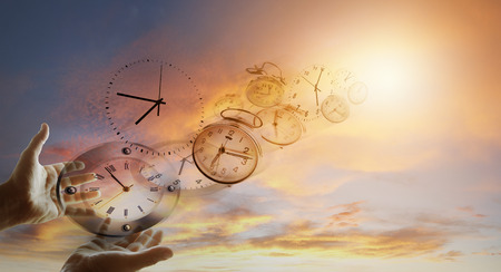 Hands and clocks in skyの写真素材