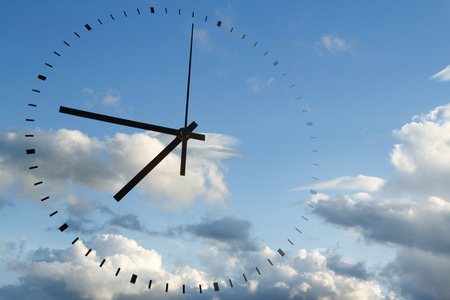 Clock face in blue skyの写真素材