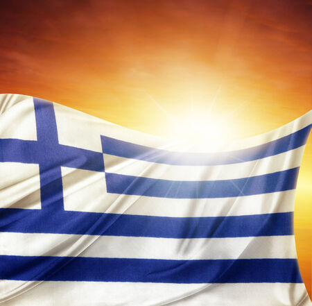 Greek flag in front of bright skyの写真素材