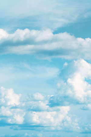 Fluffy clouds in a blue skyの写真素材