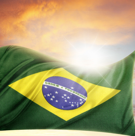 Brazilian flag in front of bright skyの写真素材