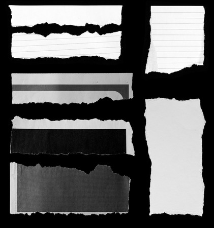 Pieces of torn paper on black. Copy spaceの写真素材
