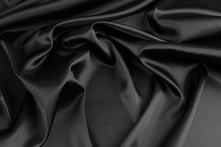 Closeup of rippled black silk fabricの写真素材