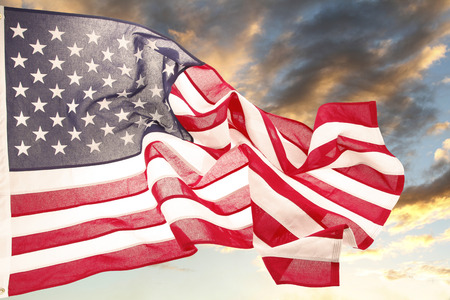American flag in front of bright skyの写真素材