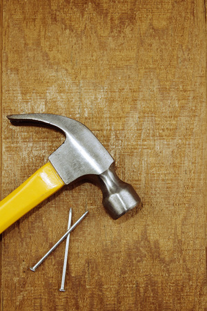 Hammer and nails on woodの写真素材
