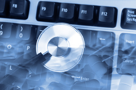 Closeup of stethoscope on keyboardの写真素材