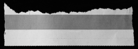 Piece of torn paper on blackの写真素材