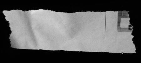 Piece of torn paper on blackの写真素材