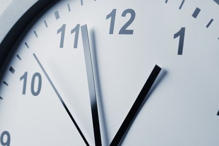 Closeup of hands on clock faceの写真素材