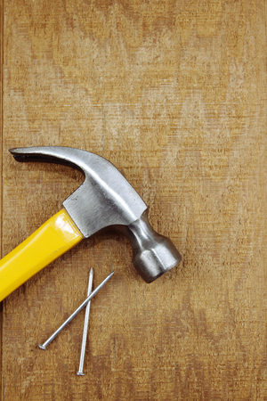 Hammer and nails on woodの写真素材