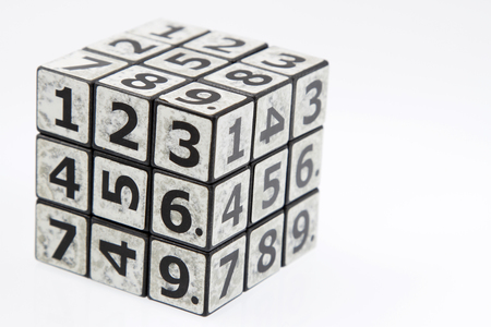 Numbers puzzle cube on plain backgroundの写真素材