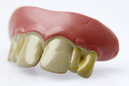 Novelty teeth on plain background