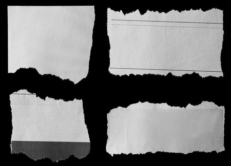 Pieces of torn paper on black Pieces of torn paper on black