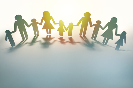 Family paper chain cutout holding handsの写真素材