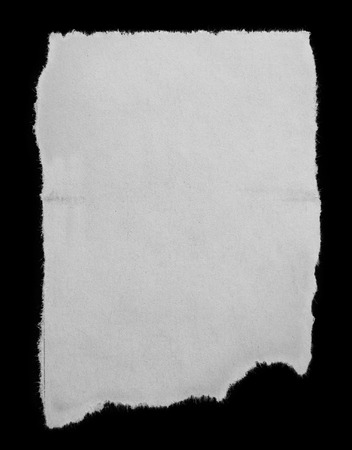 Piece of torn paper on blackの写真素材