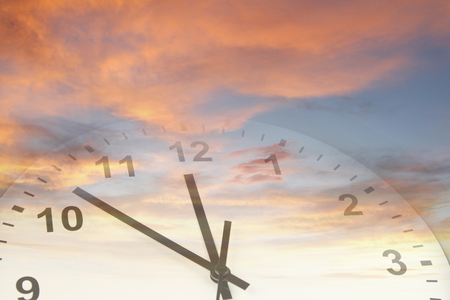 Clock face in bright skyの写真素材