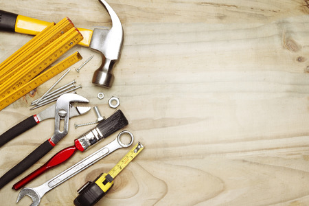 Assorted work tools on wood. Copy space