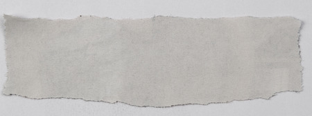 Piece of torn paper on plain backgroundの写真素材