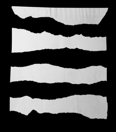 Pieces of torn paper on blackの写真素材