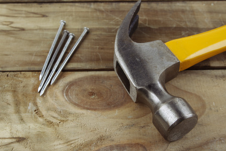 Hammer and nails on woodの写真素材