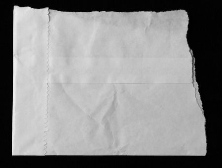Piece of torn paper on blackの写真素材