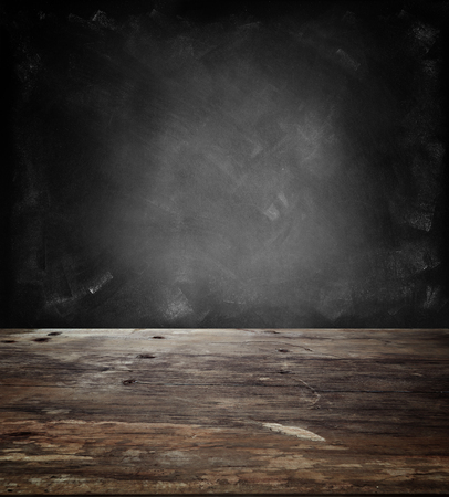 Wooden table top and blank blackboardの写真素材