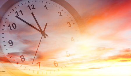 Clock face in bright sky. Time passing